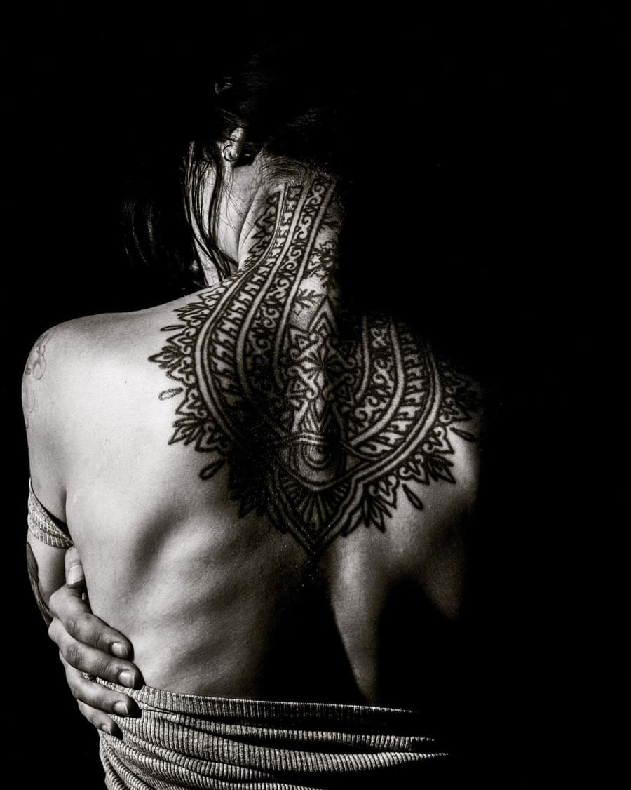 Healed ornamental mandala and dotwork running down a spine