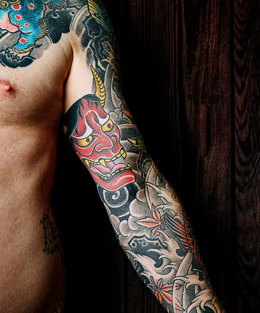 Healed full colour sleeve with a red hannya mask, waves and blossom