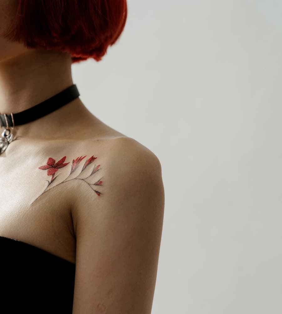 Fresh red botanical sprig on a collarbone