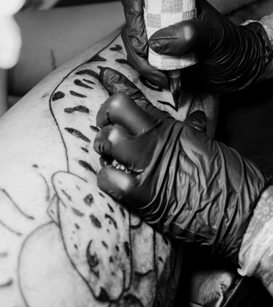 Jonah's black gloves and machine over a half-finished blackwork piece