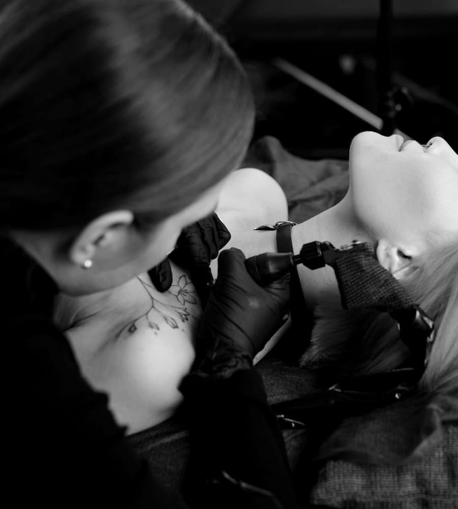 Mira Kovač tattooing fine linework on a client's shoulder