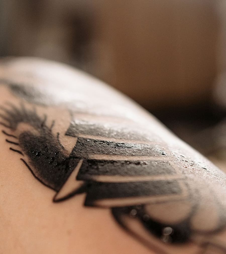 A black tattoo mid-heal, the surface dull and lightly flaking